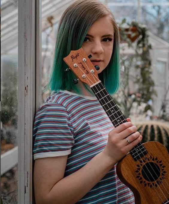 Elise Ecklund pose for a picture with her ukulele.